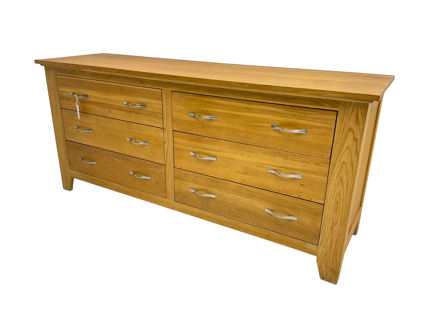 Contemporary wide oak straight-front chest, fitted with a bank of six drawers with chrome handles, on tapered feet