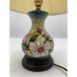 Moorcroft table lamp of baluster form, decorated in the Hibiscus Moon pattern, with Moorcroft cream fabric shade with yellow, green and pink piping, overall H40cm