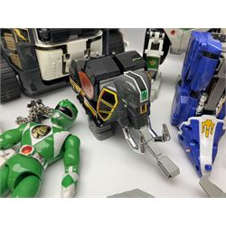 Collection of early 90s Mighty Morphin’ Power Rangers Zords, figures and accessories. Titanus the Carrier Zord, marked Bandai 1991; Green Dragonzord, incomplete; 1994 White Tigerzord with original instruction manual; 1993 Triceratops Dinozord, Mastodon Dinozord and Sabertooth Tiger Dinozord, Pterodactyl Dinozord, missing guns; with 1993 Power Morpher and original Power Coins, with further related figures, accessories and weapons