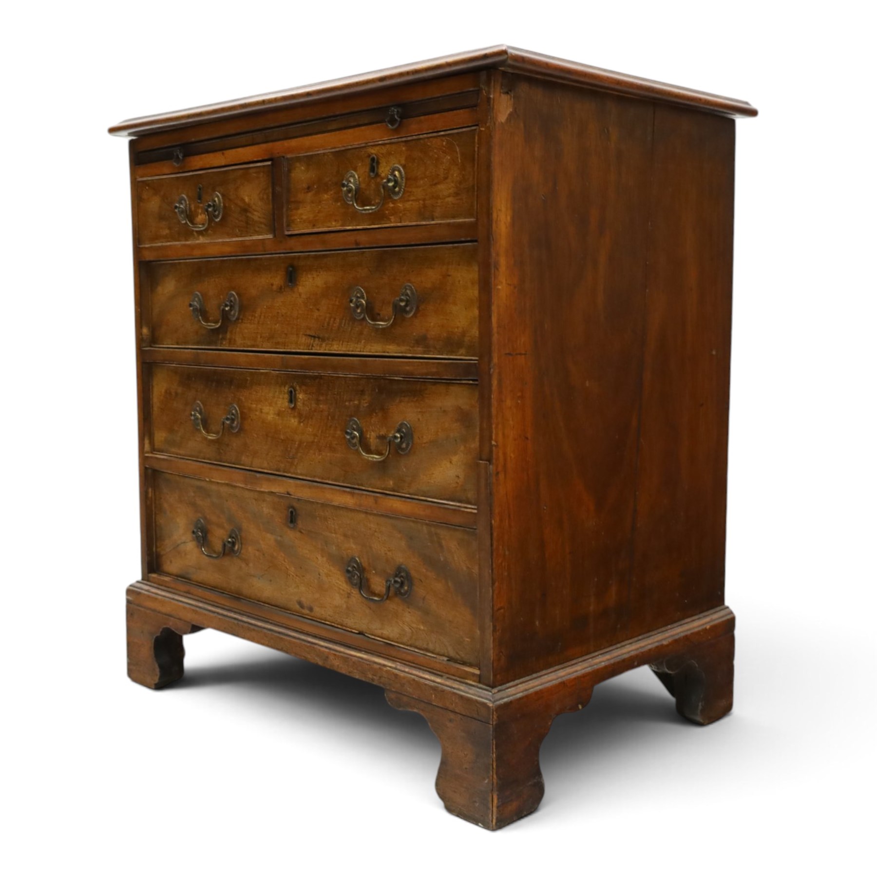 George III mahogany bachelors chest, rectangular top with moulded edge, fitted with brushing slide over two short and three long cock-beaded drawers with brass swan-neck handles, lower moulded edge on bracket feet