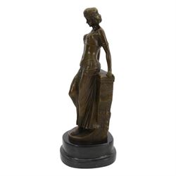 After Milo; Egyptian lady leaning on a wall with sphinx carving, upon a stepped oval base H25cm