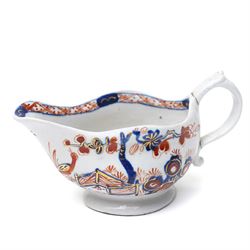 18th century Vauxhall porcelain cream boat with scroll handle, painted with underglaze blu...