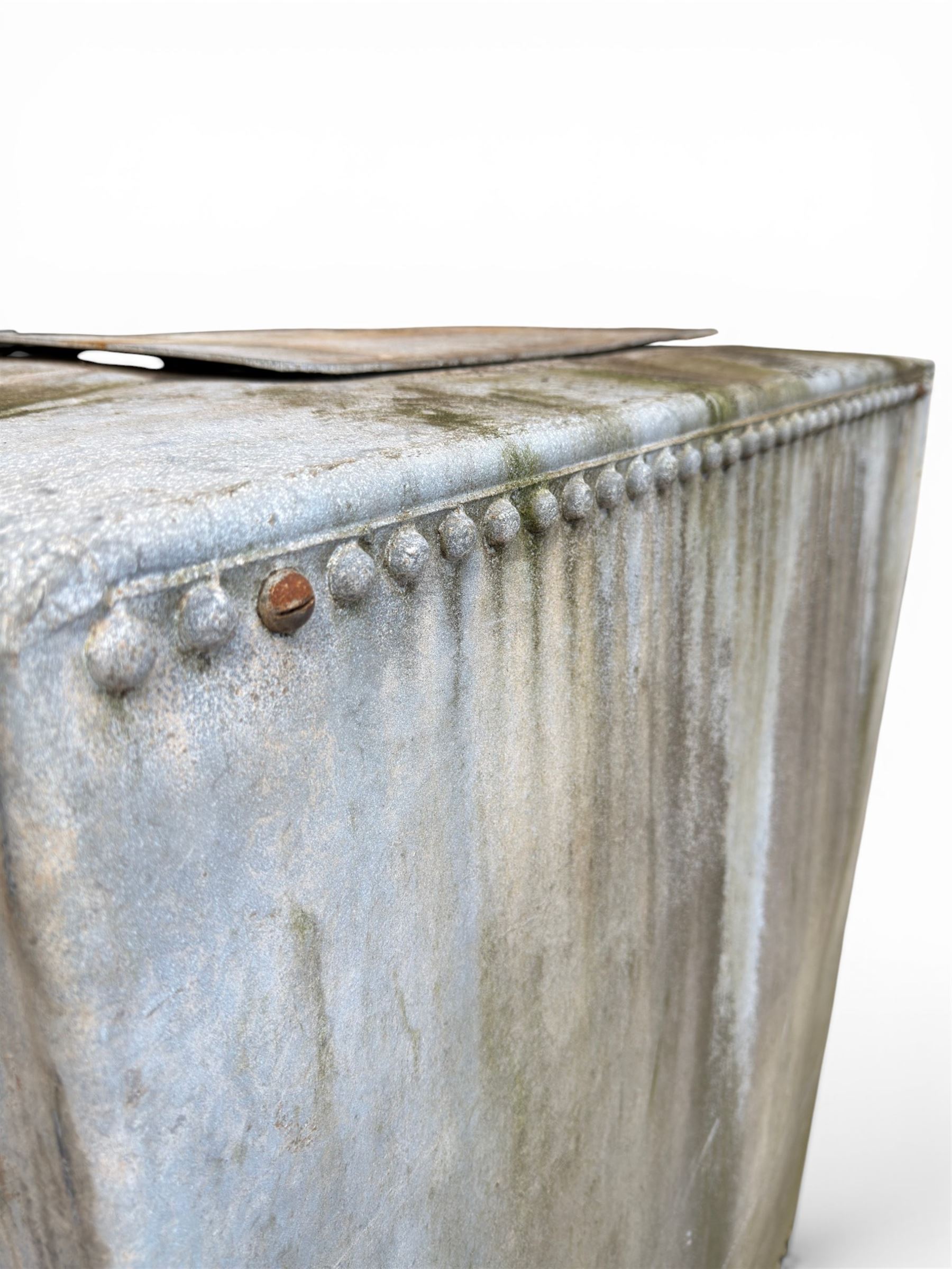 Large early 20th century galvanised water, cube form  with rounded corners and buttoned detail, with tap