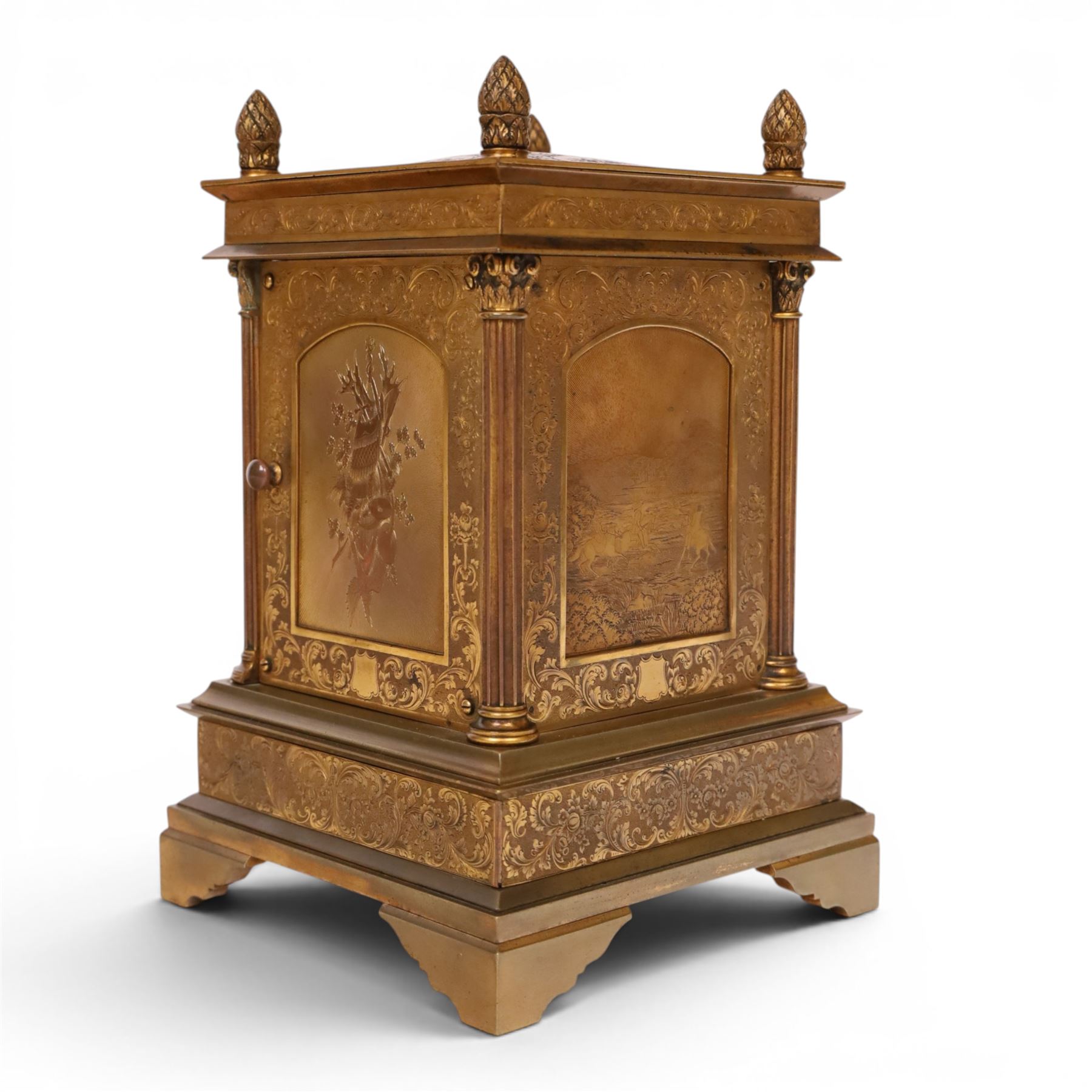 Early 20th century brass mantle clock, the face and case profusely engraved with floral scrolls, the sides inset with hunting scene panels, flanked by four Corinthian columns with acorn finials, striking the hours and halves on bell, H20.5cm W13cm