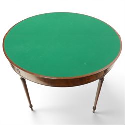 Georgian mahogany demi-lune card table, the lunette shaped top with cross-banded and boxwood-strung edge, opening to reveal baize-lined interior and supported by rear gatelegs, over a banded frieze with applied oval plaques, raised on turned and tapering supports