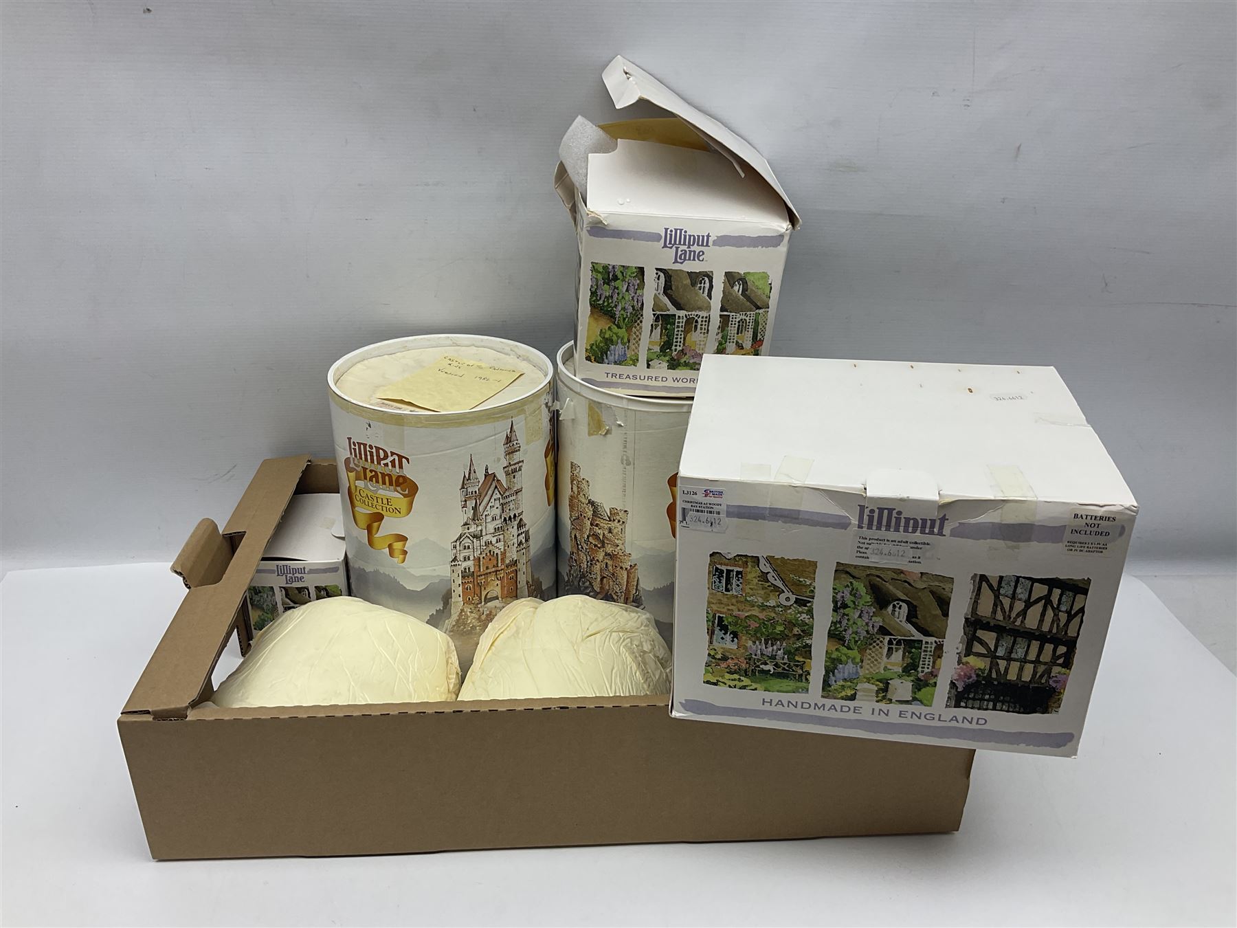 Five Lilliput Lanes, comprising Christmas at Woody Bay Station and Calling Home for Christmas both from the Illuminated collection, Castle of the Exiled Prince, Castle of The Ransomed King and Helvellyn, all with original boxes (5)