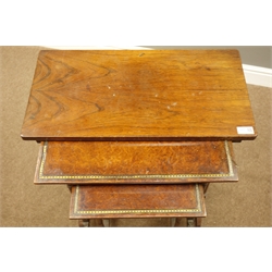  Two early Victorian amboyna wood nesting tables, on collar turned rosewood supports with splayed feet, brass floral and bead mounts, and a similar period rosewood table  