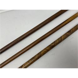 Three early 20th century walking sticks, to include a smoking pipe walking stick, the cane opening to reveal a concealed pipe, and a wooden walking cane, the metal cover with inscription 'bell metal and wood of York Minster, Burnt May 20 1840, and a turned wooden walking stick, with marquetry checkerboard pommel, tallest L90cm