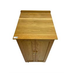 Bespoke light oak floor standing medal cabinet with two panelled doors enclosing fourteen graduated drawers with brass knob handles, on castors W45cm H98cm D50cm