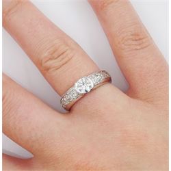 18ct white gold diamond ring, half bezel set with a single round brilliant cut diamond of approx 0.45 carat, with pave set round cut diamond shoulders, hallmarked