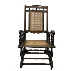 Early 20th century beech American rocking chair, with caned seat and back