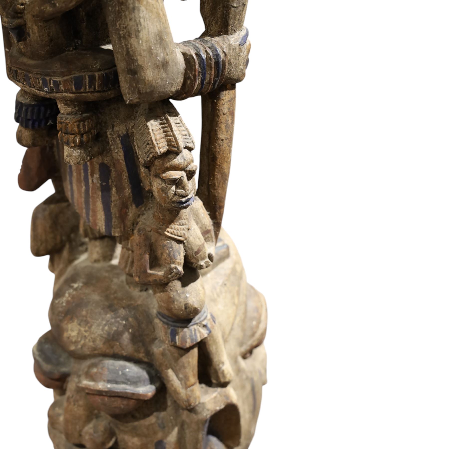 African tribal maternity figure of a woman with children, probably Yoruba, carved wood, the woman stood upon a craved mask, H133cm