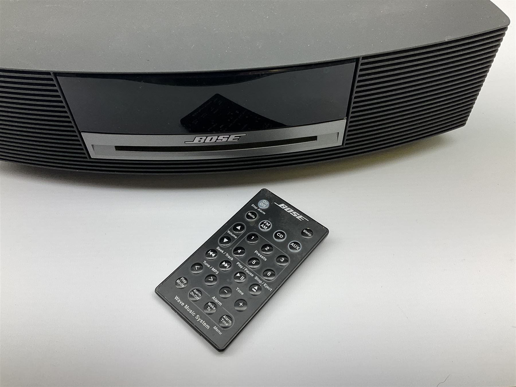 A Bose Wave music system, model AWRCC5, with remote control. 