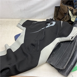 A collection of assorted sized wetsuits, comprising examples, by Osprey, Saltrock, TWF, Alder, Banana Bite, together with four pairs of flippers, three masks and snorkels, and a Buddy Commando Profile BCD vest. 