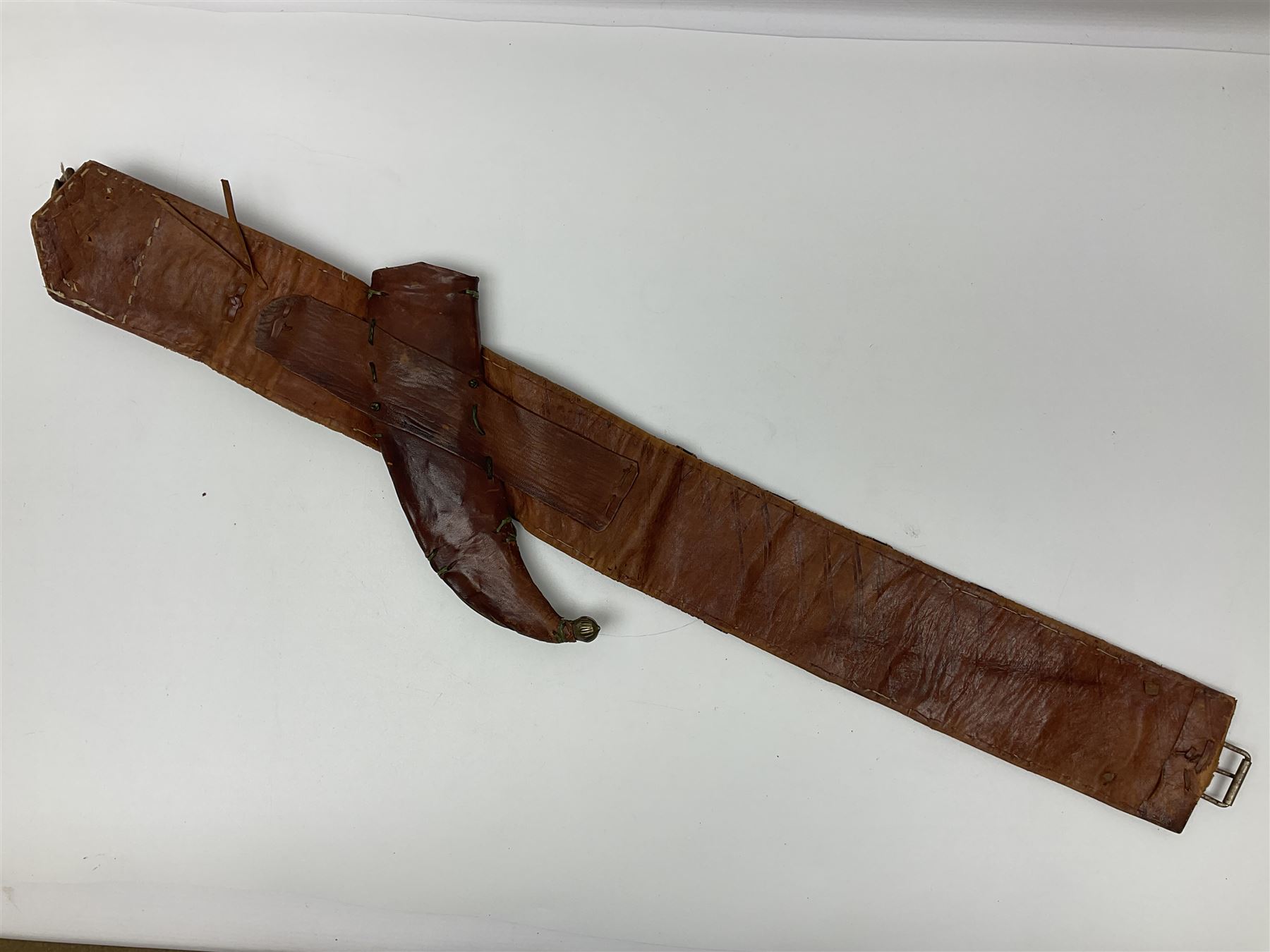 Late 19th century Yemeni Tuza jambiya as worn by religious elite, the 20.5cm curving blade with raised medial ridge, the horn hilt with pique style studwork, in a leather wrapped wooden scabbard with pierced metal mount and leather belt applied with embroidered 'gold' and 'silver' thread work panel; dagger L36cm overall, belt L84cm