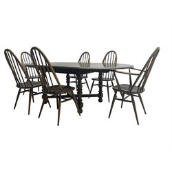 Ercol - 'Old Colonial' 705 elm extending dining table, oval top with hidden leaf, raised on turned supports united by X-stretcher (W163cm D108cm H72cm); and Ercol - set six  (4+2) dark elm 'Quaker Back Windsor Dining Chairs', hoop and stick backs 