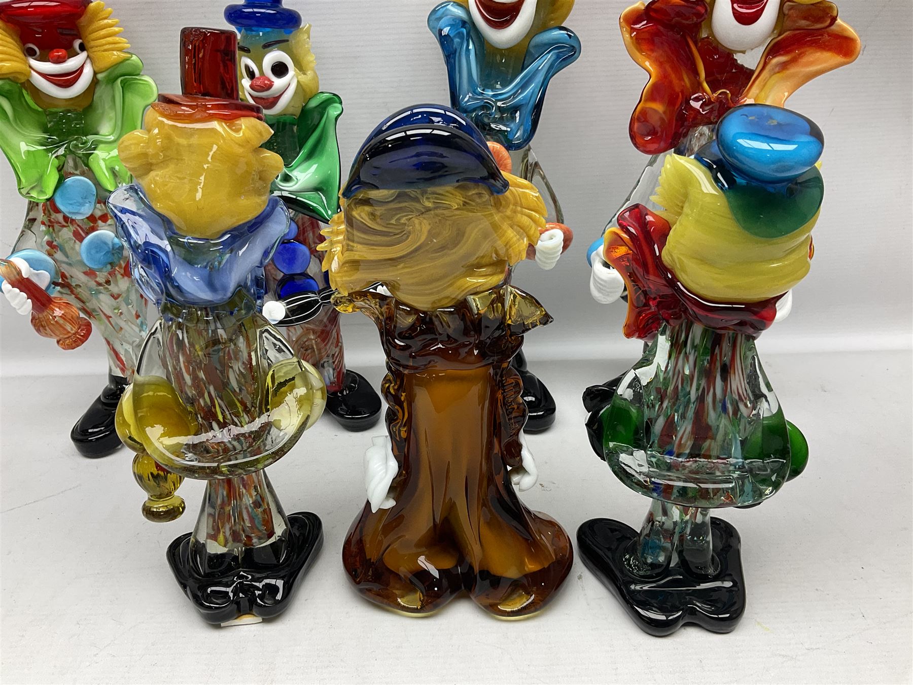 Large quantity of Murano glass clowns, to include larger examples, in two boxes