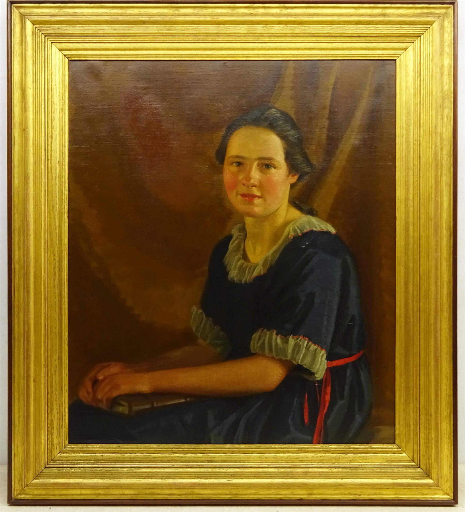 James P Barraclough (British 1891-1942): Half Length Portrait of a Young Woman in a Blue Dress, oil on canvas signed 75cm x 62cm 
Provenance: by direct descent through the artist's family