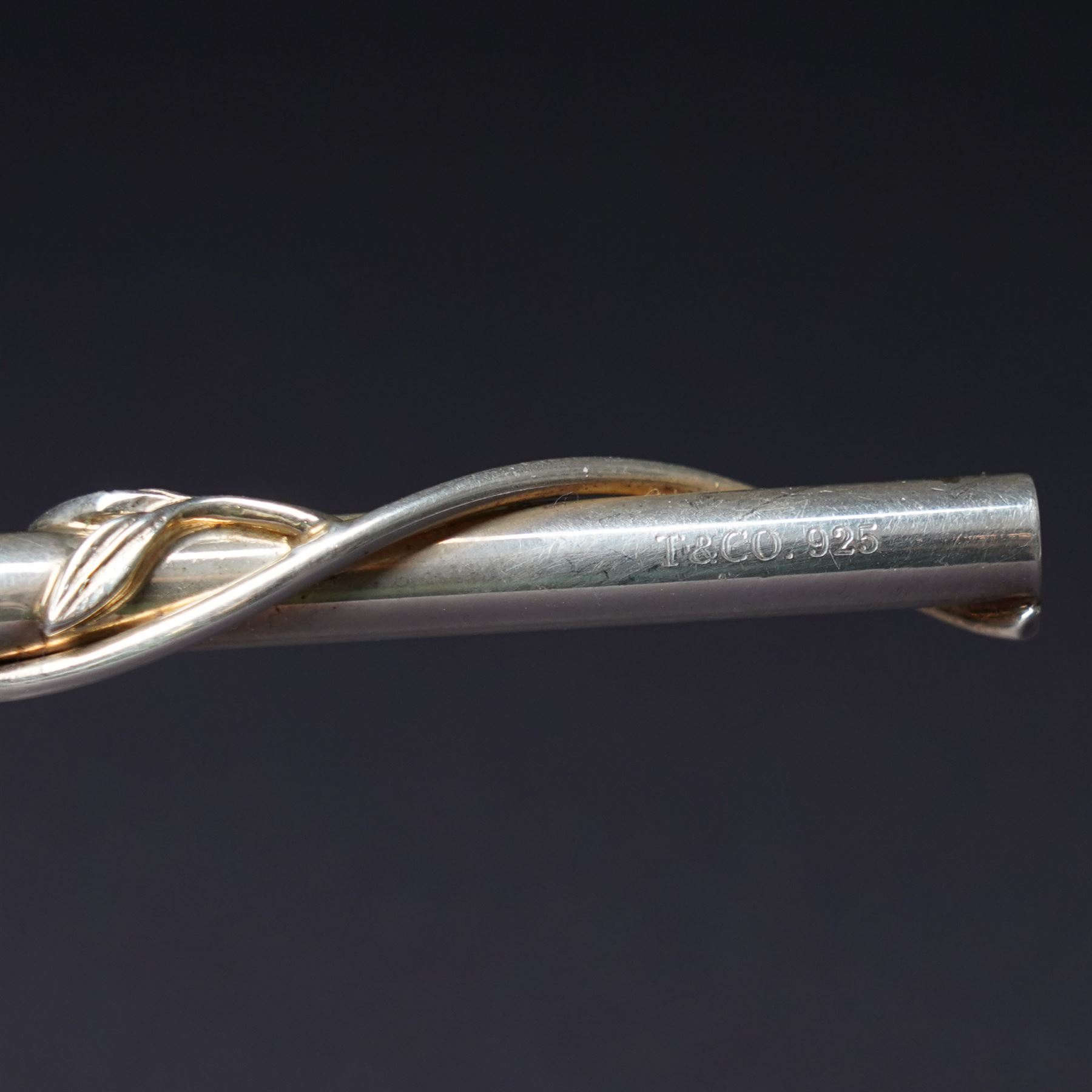 A pair of Tiffany & Co. novelty silver drinking straws, each modelled as a bamboo stem entwined with leaves and applied with a climbing monkey figure, engraved with names and date, stamped TIFFANY & CO. 925, W21cm