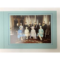 H.M. Queen Elizabeth II and HRH The Duke of Edinburgh, signed 1980 Christmas card with twin gilt Royal ciphers to cover and colour photographic print of eleven Royal Family members in Buckingham Palace to the interior; signatures of Elizabeth R and Philip with manuscript date 1980 below