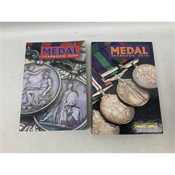 Eleven medal reference books including Ian Bisset: The George Cross; Spinks British Battles & Medals; William Spencer: Medals - The Researchers Guide; John D. Clarke: Gallantry Medals & Decorations of the World; Officers of The Green Howards 1931-1972; and six others (11)
