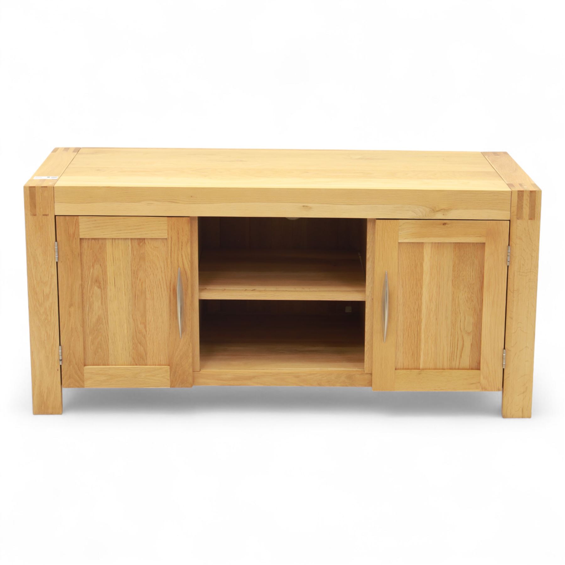 Contemporary solid oak television stand, rectangular top over an open central section with adjustable shelf, flanked by cupboard doors with vertical recessed panel fronts and brushed steel handles, on block feet