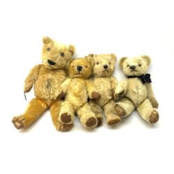 Four English teddy bears 1930s-50s comprising Chiltern with revolving head, plastic eyes and plastic dog type nose, jointed limbs with velvet paw pads and back aperture for key-wind musical movement H17