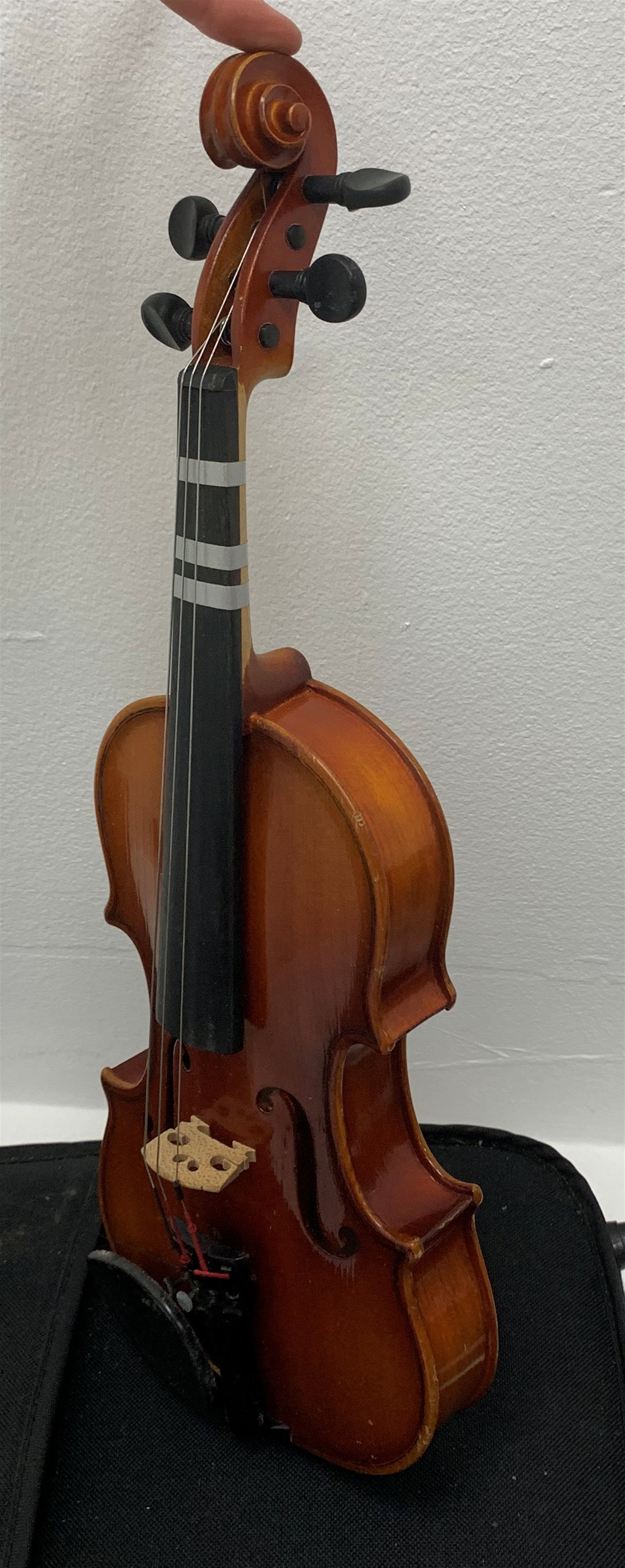 Three modern graduated violins - Suzuki 1/10 size child's violin with 23.5cm single piece back, bears label serial no.94282, 40cm overall; copy of Antonius Sradivarius of Cremona violin dated 1998 with 28cm two-piece back, 47cm overall; and Strobel violin with 35.5cm two-piece back, bears label dated 2006, serial no.512801325, 59cm overall. All cased with bows (3)