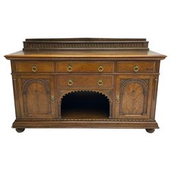 Edwardian oak sideboard, raised arcade carved back over rectangular top, fitted with four drawers, two arch carved doors doors flanking open arched centre, on turned feet