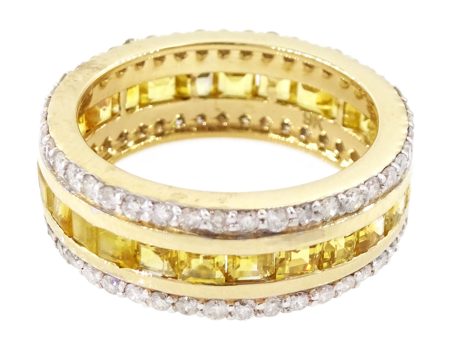 Gold yellow sapphire and diamond three row full eternity ring, channel set calibre cut sapphires, with a row of round brilliant cut diamonds set either side, stamped 9K, total sapphire weight approx 2.95 carat, total diamond weight 0.85 carat