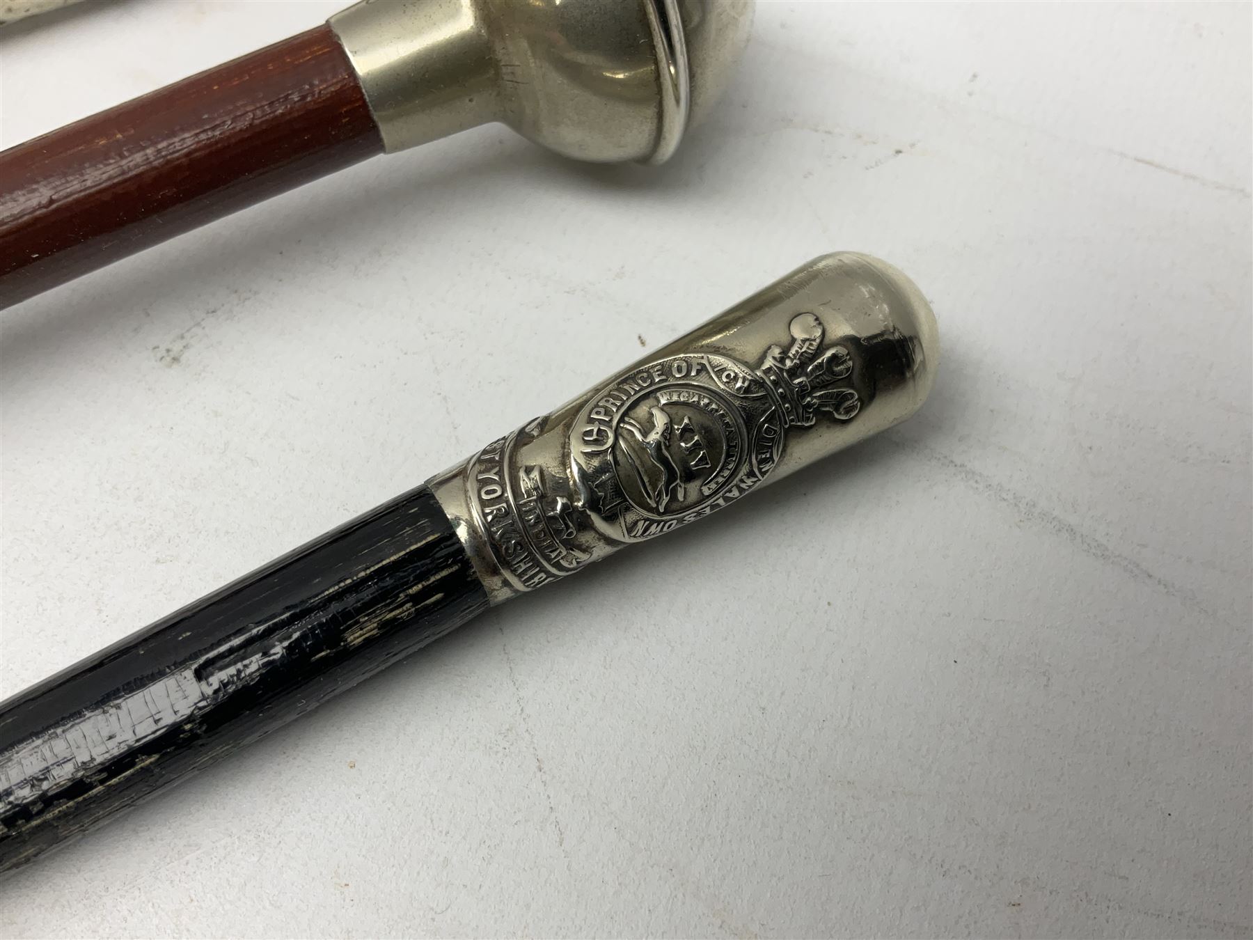 Three military swagger sticks - 14th Foot West Riding POWO Regiment; Northern Cyclist Battalion; both with regimental crests; and another with spherical terminal inscribed L/Cpl. Boycott P.M. WC. C.C.F. 7th Dec. 1960 (Combined Cadet Force?); all with plated mounts (3)