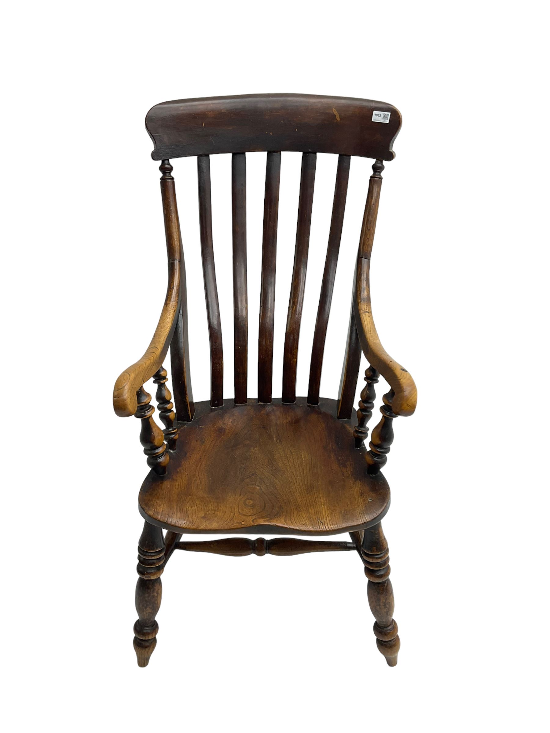 Late 19th century elm farmhouse armchair, high lath back raised on turned supports united by stretcher