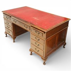 Late 19th century mahogany pedestal desk, rectangular top inset with worn red leather writing surface with gilt tooling, three frieze drawers above opposing pedestals each fitted with four graduated drawers, brass swan neck handles and escutcheons, panelled sides and back, raised on turned feet