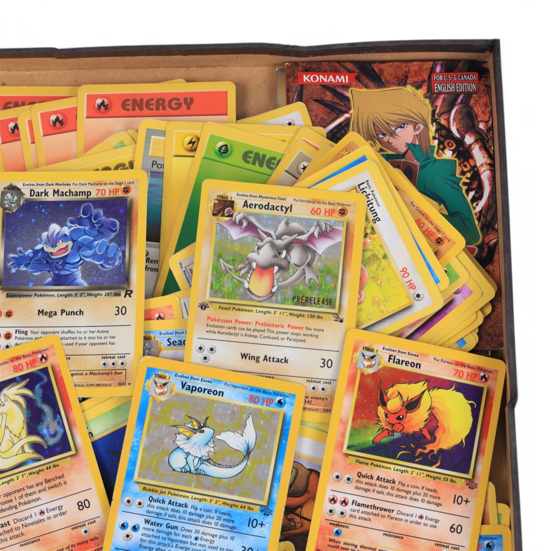 Collection of  Wizards Of The Coast Pokemon trading cards including Base Set, Jungle Set, Fossil Set and Team Rocket examples, black star promo Mew, Arcanine and Pikachu, holo Ninetales and Clefairy, 1st edition pre-release holo Aerodactyl, Team Rocket Dark Machamp holo and Jungle set Flareon, Vaporeon and Scyther holos 