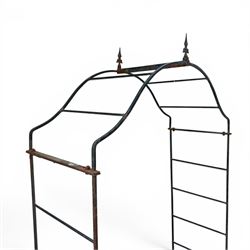 Antique wrought iron strapwork garden arch, with scroll form arched top with spearhead finials, over integral side trellis panels, in distressed black-painted finish