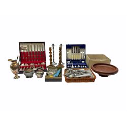 Collection of flatware, two cased canteens, a pair of white metal candled stick, a pair of wooden candlesticks, a footed wooden dish etc