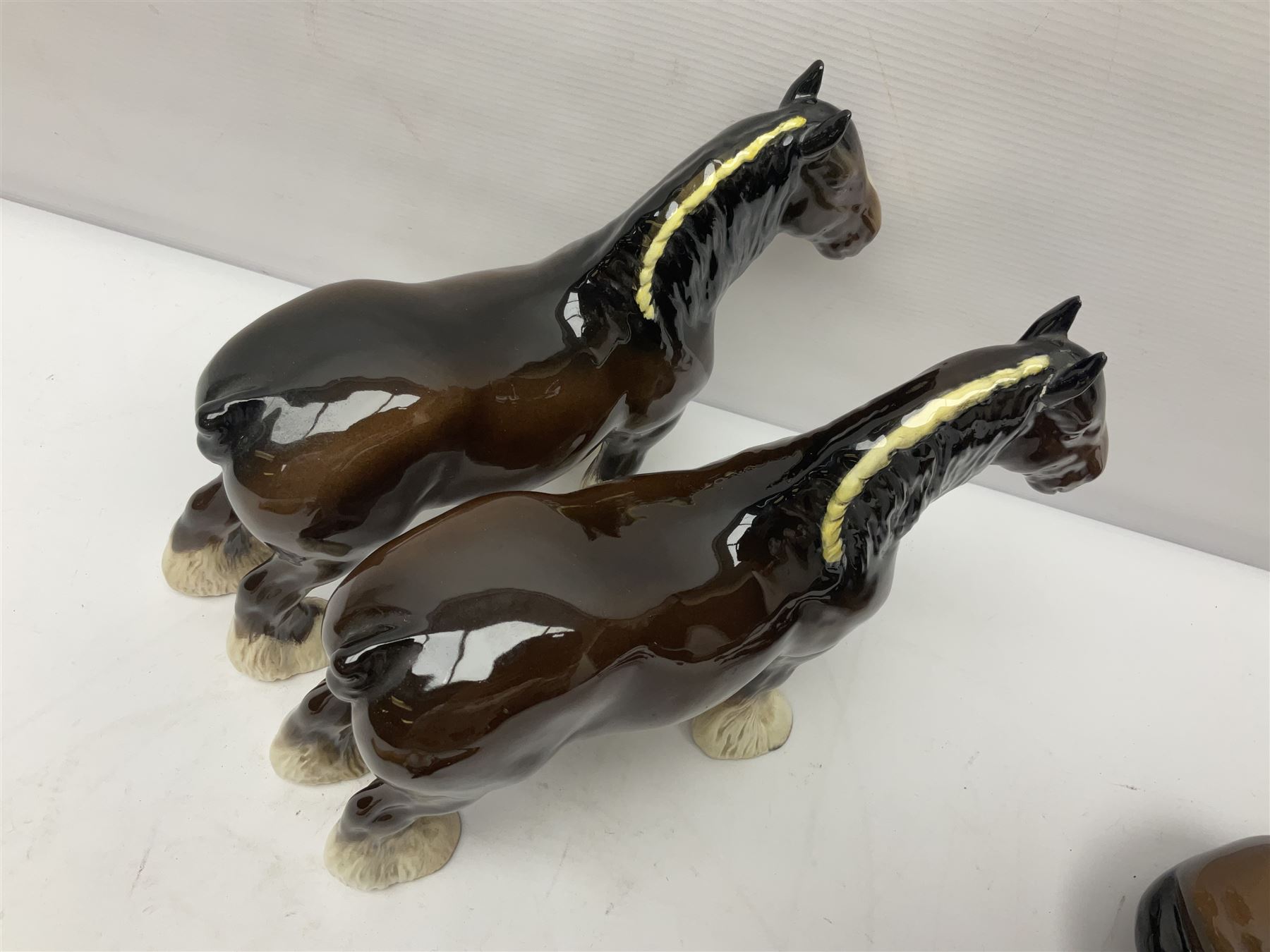 Four Beswick horse figures, comprising Quarter Horse, two Shires no 818 and matt palomino, together with Beswick donkey and Royal Doulton horse on a wooden plinth  