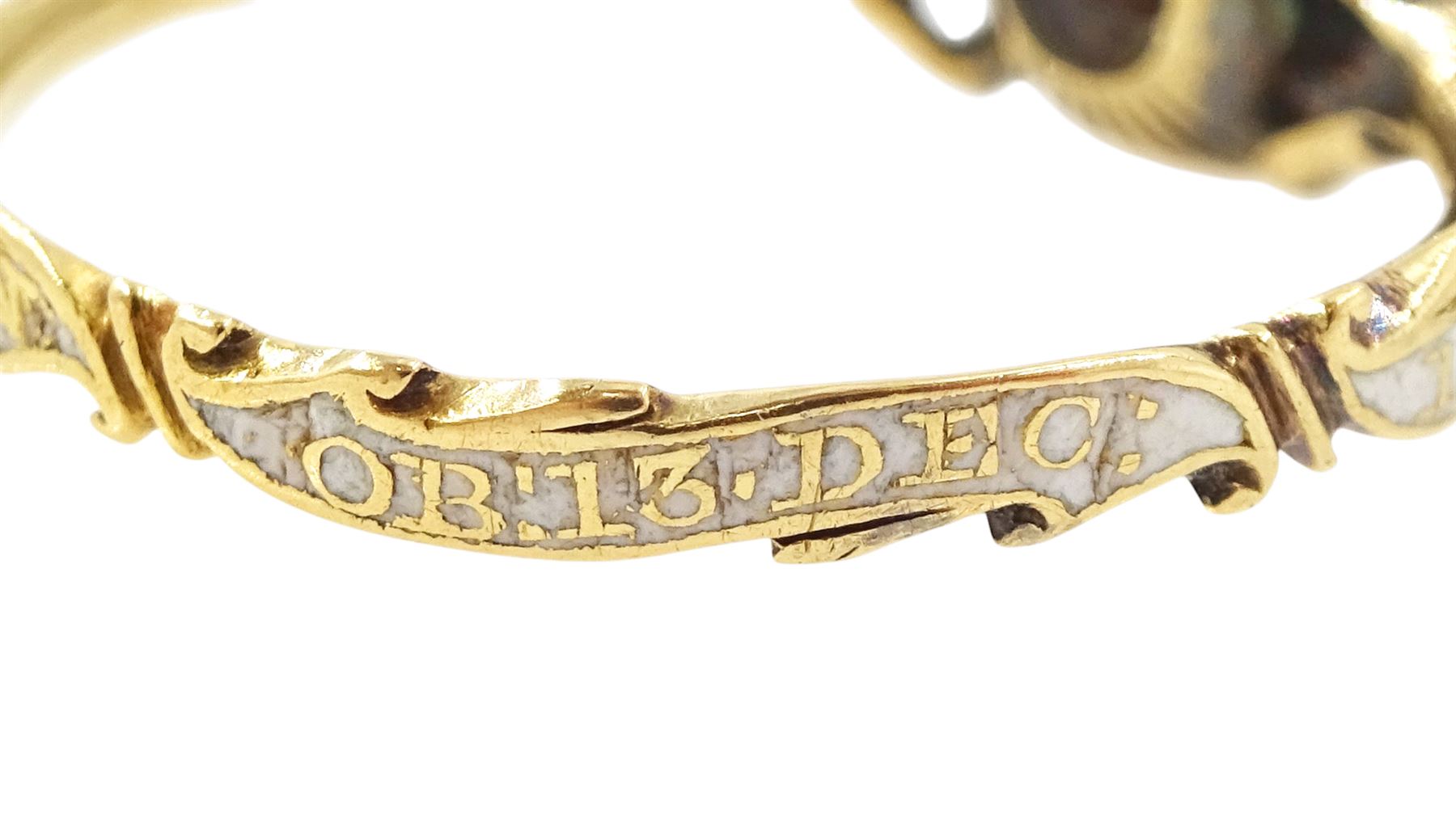 George II 18ct gold amethyst and enamel mourning ring, single cushion cut amethyst, with foiled and glazed back, to pierced fleur-de-lis shoulders, the white enamelled shank engraved Grace Hutchinson OB: 13 Dec: 1756