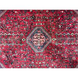 Persian Kashan crimson ground rug, hexagonal field decorated with central medallion and surrounding bird plant and animal motifs, guarded border with repeating floral and bird design