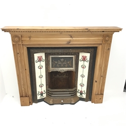 Cast iron inset fire with Art Nouveau style tiles, pine surround, W141cm, H117cm
