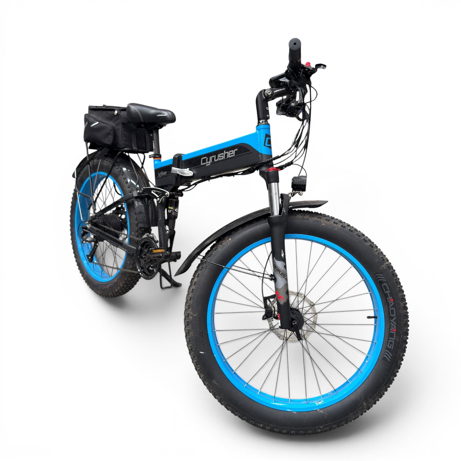 Cyrusher XF690 Plus - electric fat tyre bicycle, 250W model, with suspension forks, disc brakes, rear pannier bag and blue and black finish.