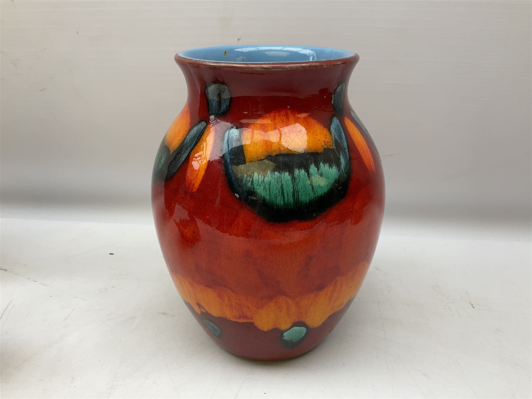 Collection of Poole Pottery, comprising charger and vase in Volcano pattern and a duck figure in a similar pattern 