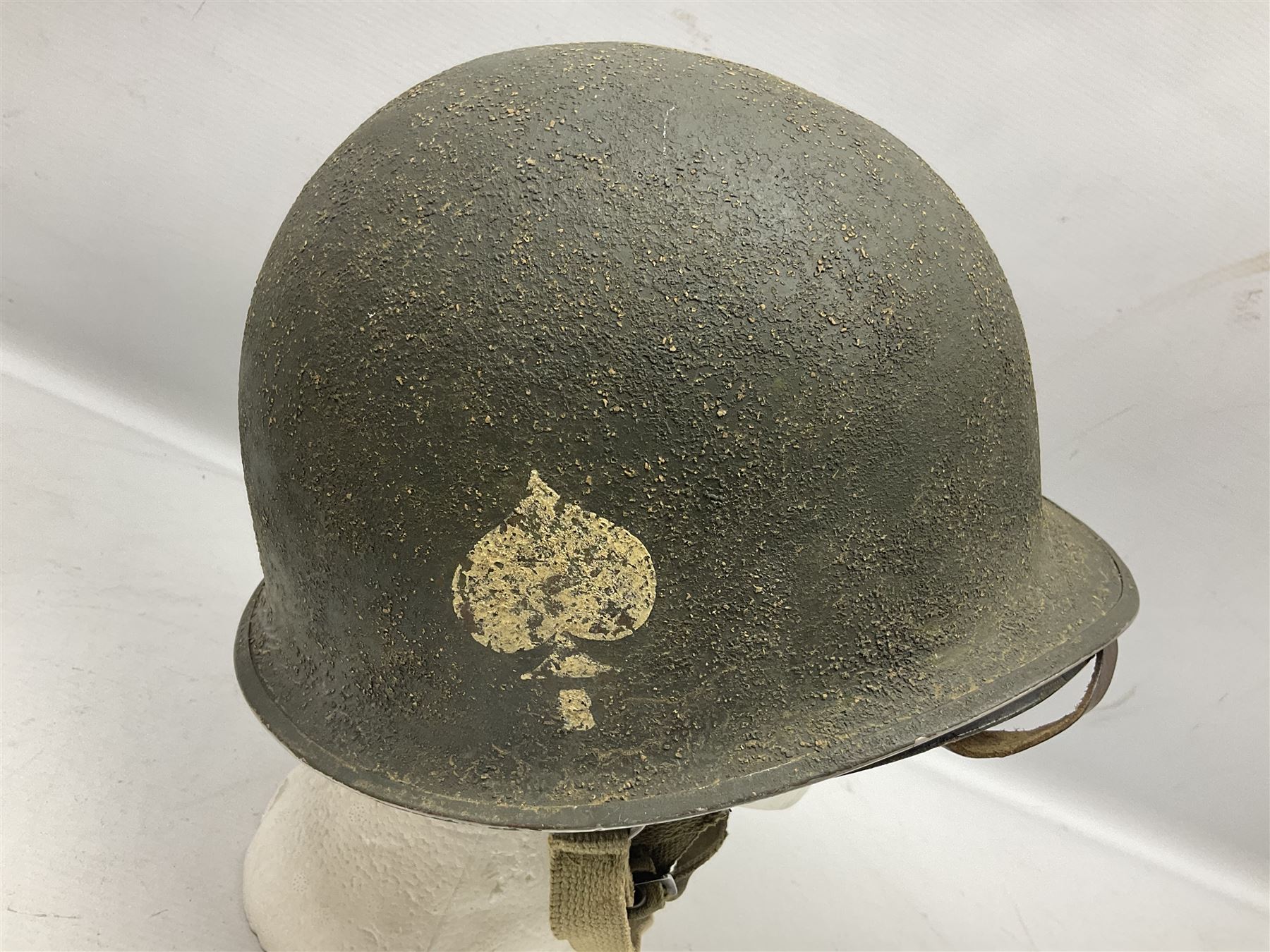 American first type paratrooper helmet with post-WW2 strap and D-rings and later 1944 liner bearing Firestone Tyre and Rubber Company mark; green textured finish