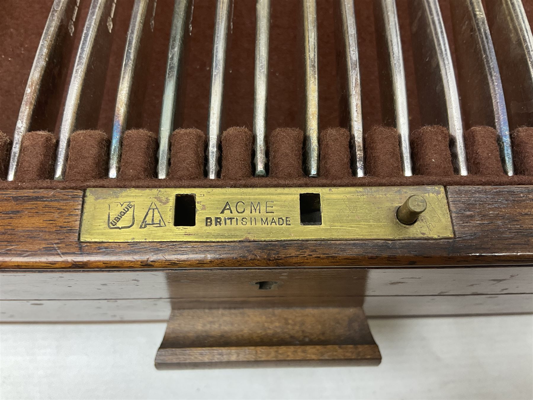 Elkington & Co part canteen of silver plated and stainless steel cutlery, to include simulated ivory handled examples, housed in oak and mahogany case, lock plate stamped 'Acme, British Made', W49cm D31cm H18cm