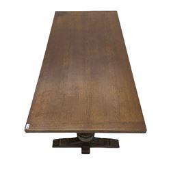 20th century oak drawer leaf extending dining table, two foliage carved baluster supports on sledge feet joined by floor stretcher 