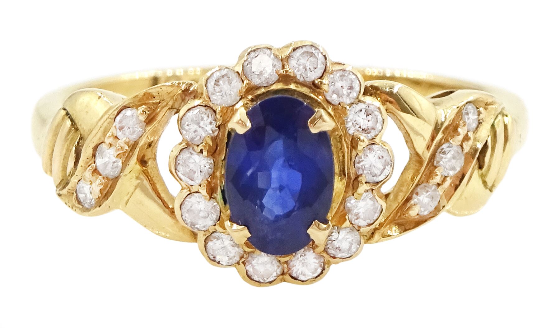 18ct gold sapphire and diamond cluster ring, single oval cut sapphire of approx 0.50 carat, surrounded by fourteen round brilliant cut diamonds, with pierced crossover diamond set shoulders, stamped, total diamond weight approx 0.20 carat