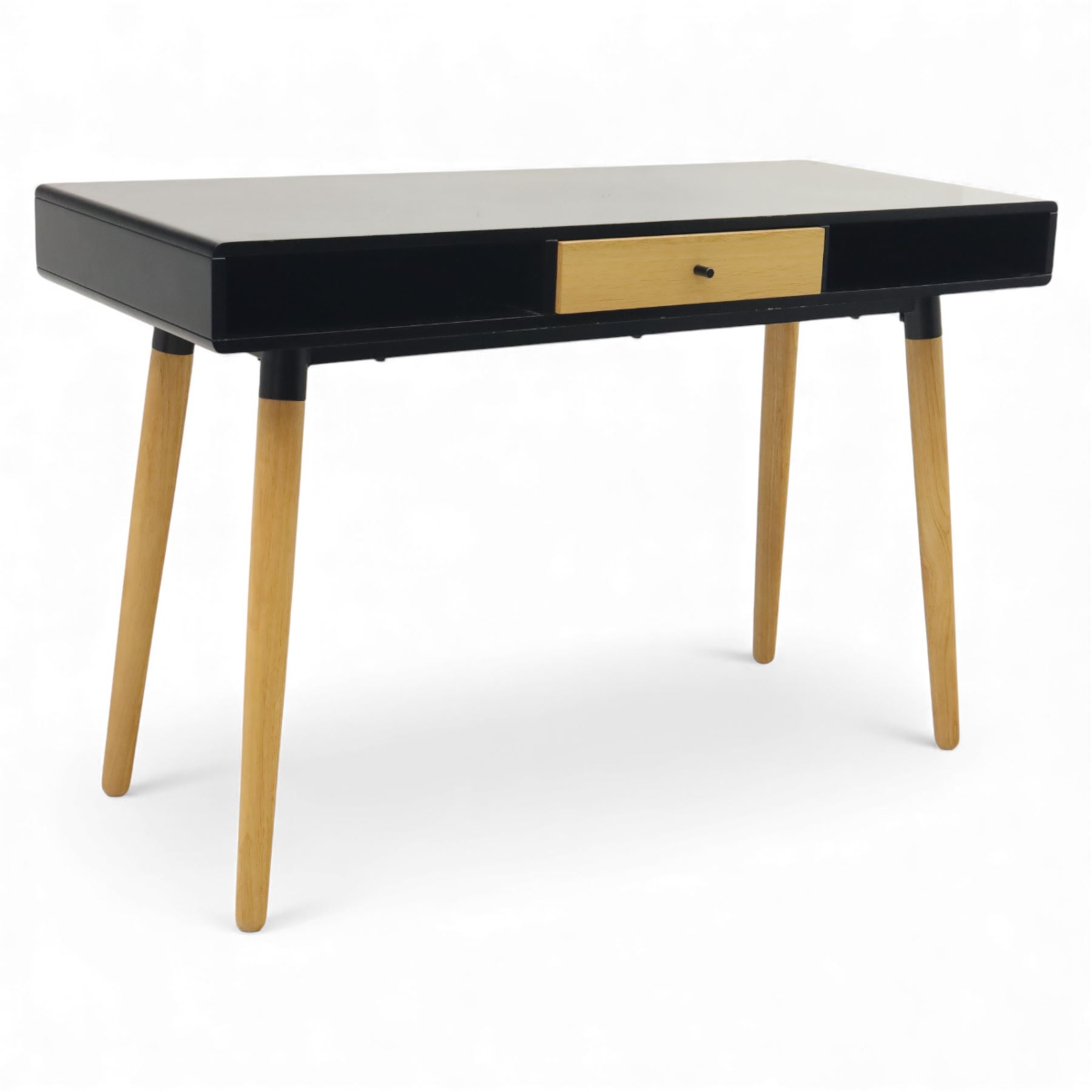 Modern black single drawer desk, black rectangular top above a single oak veneered drawer with black metal pull, flanked by two open shelves raised on tapering oak veneer legs (From floor to underside 64cm)