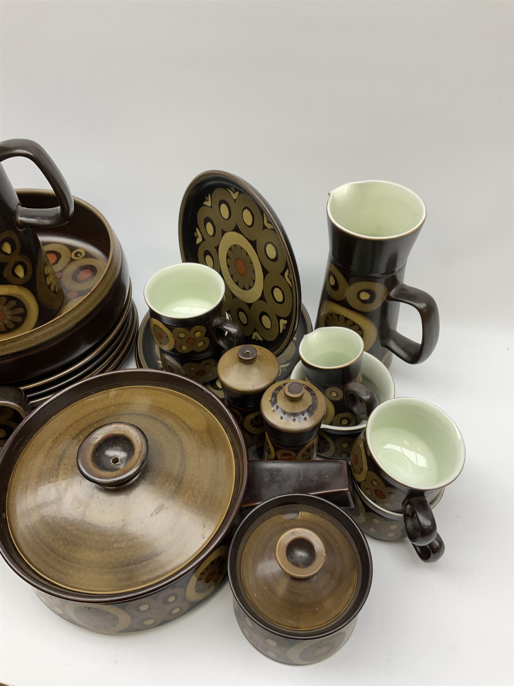 Denby Arabesque pattern tea and dinner wares, comprising large serving bowl,  five dinner plates, three side plates, four twin handled bowls and covers, one bowl and cover, four bowls, salt and pepper shaker, pan with lid, six egg cups, small serving dish, coffee pot, water jug, milk jug, jug with handle,  two sucriers and covers, four tea cups and one coffee
