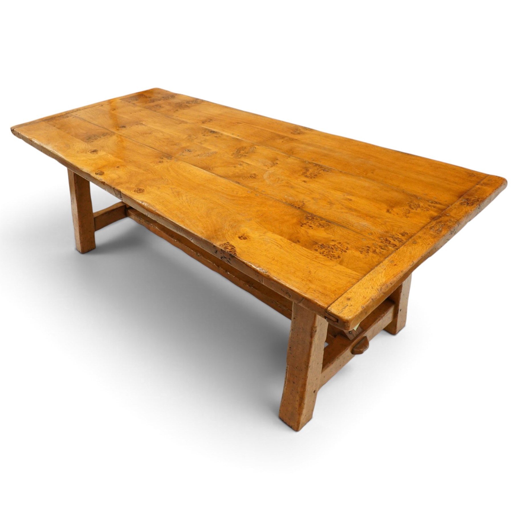 Quality golden figured and burr oak farmhouse refectory dining table, the rectangular plank top with cleated ends, raised on square supports united by arched and H-stretcher trestle base