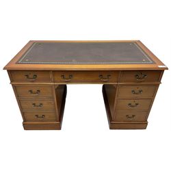 Cherrywood twin pedestal desk, rectangular leather inset top over central fall front with keyboard slide and two drawers, fitted with two drawers and cupboard, on bracket feet